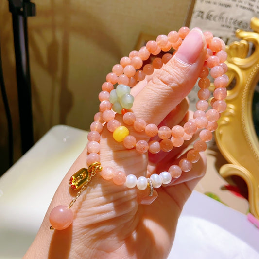 Natural Sunstone Triple-Wrap Bracelet, paired with natural amber, pearls, Hetian jade four-leaf clover, and sunstone star charm.